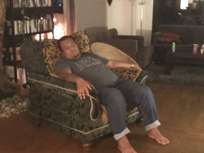 Asad Zulfahri seating on a sofa and sleeping