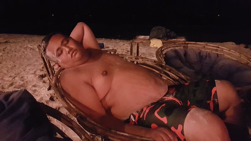 Asad Zulfahri sleeping on a beach