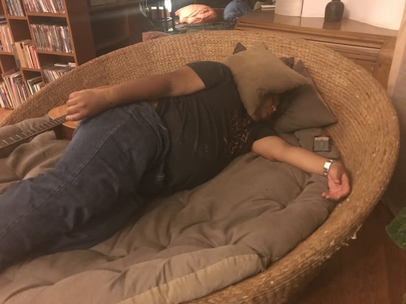 Asad Zulfahri sleeping on a big sofa bed