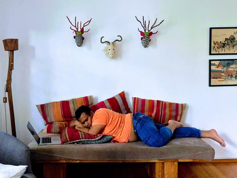 Asad Zulfahri sleeping on a couch while waiting for a meeting