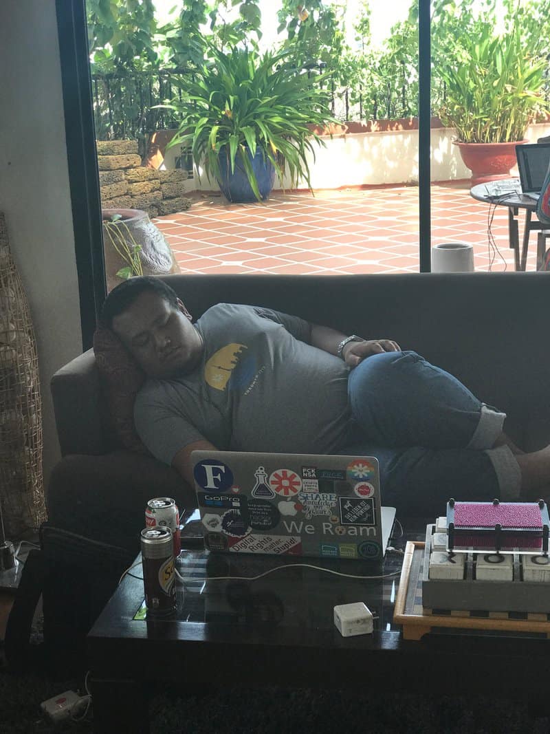 Asad Zulfahri sleeping sideways on a couch